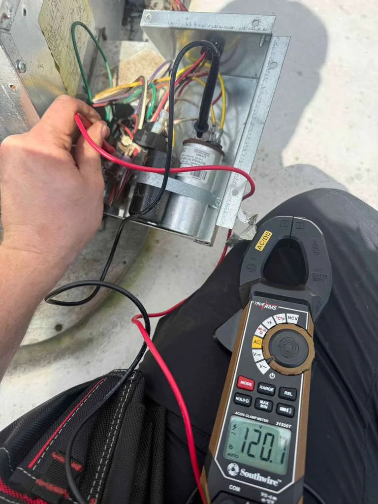 RV AC repair technician working on rooftop unit