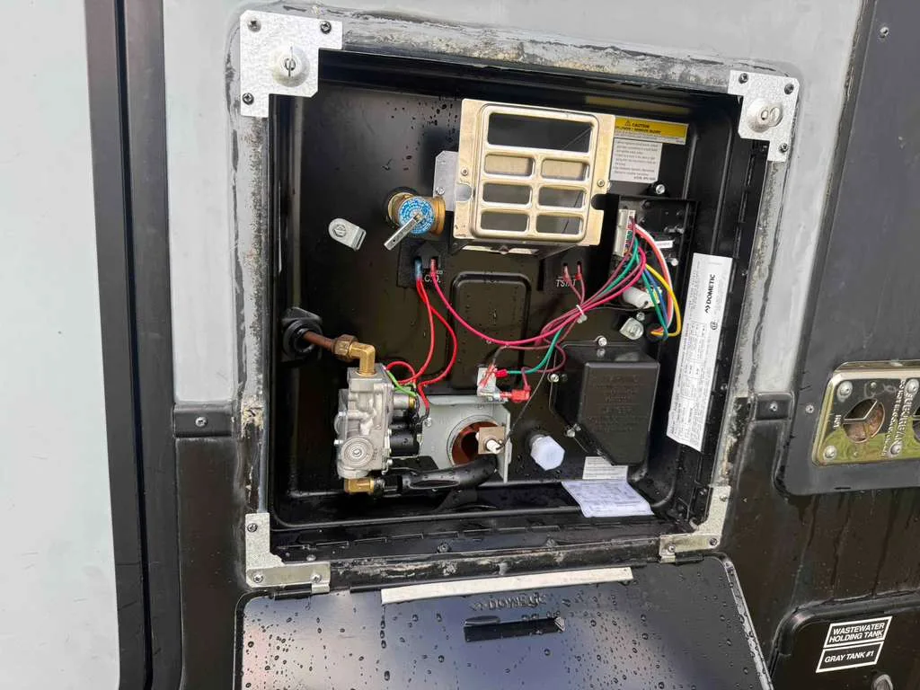 RV plumber replacing water heater on a travel trailer