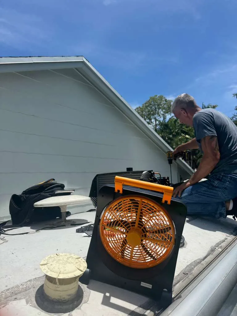 Professional roof vent fan installation on a recreational vehicle